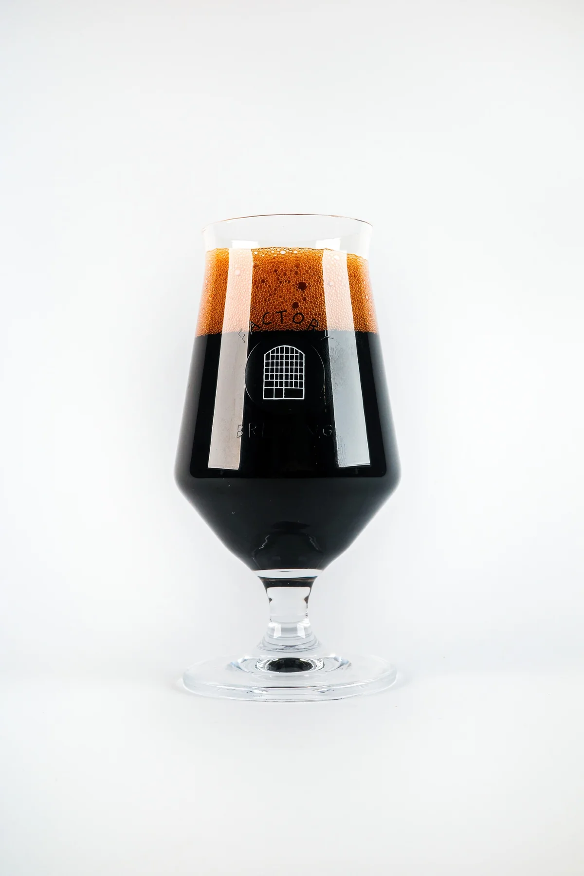 Dark craft beer in a Factory Brewing glass